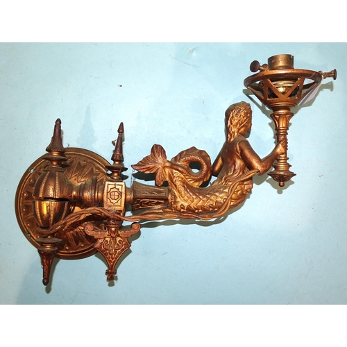 97 - Three gilt metal wall sconce light fittings, each in the form of a mermaid supporting a torch, exten... 