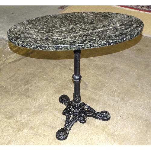 64 - A cast iron table stand with later oval-shaped granite top, 75 x 40cm, 71cm high.