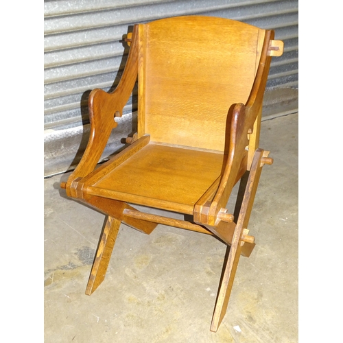 65 - A 20th century oak X-framed armchair of wedge-jointed construction, 90cm high, 45cm to the seat.... 