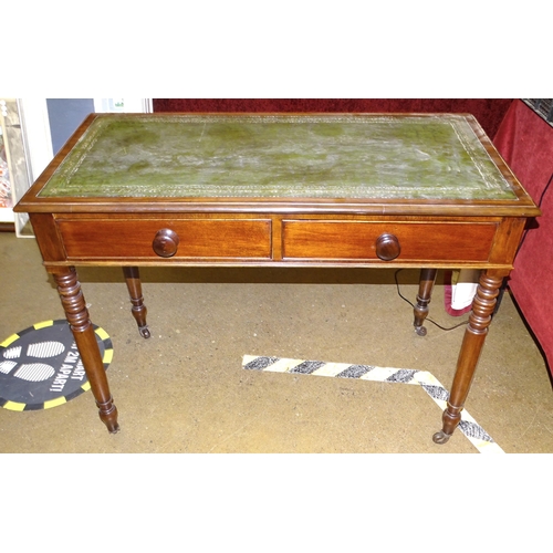 67 - A 19th century mahogany side table inset leather writing surface and two frieze drawers, on turned l... 