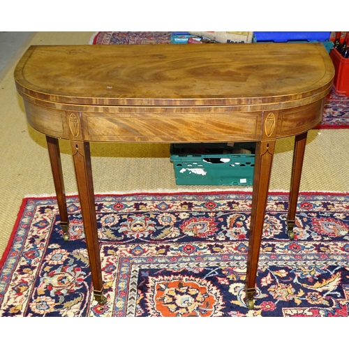 72 - A later-George-III inlaid and crossbanded mahogany fold-over tea table, on square tapered legs and c... 