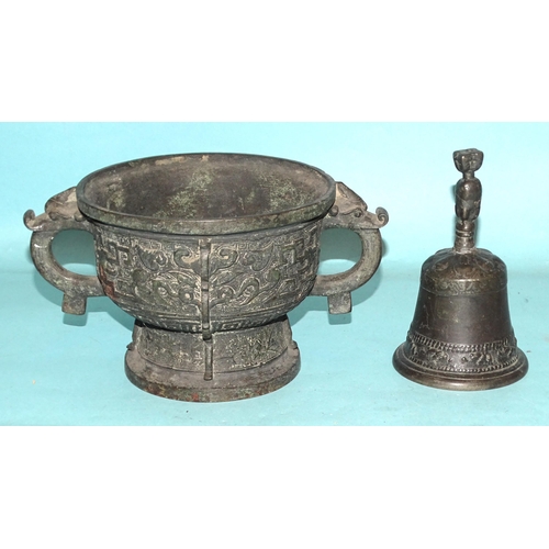 82 - An Asian bronze bowl of Indo-Chinese style, 23cm diameter and a later metal hand bell, (2).... 