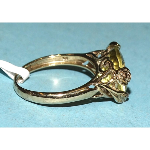 428 - A 9ct gold ring set oval citrine, in floral mount, size M½, 3.1g.