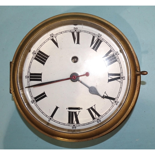 44 - A ship's brass circular bulkhead clock, with enamel dial and Roman numerals, (chip to enamel outer e... 