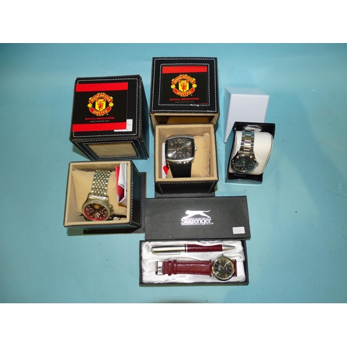 142 - Two Manchester United Official Merchandise wristwatches, boxed with papers, a Slazenger watch/pen se... 