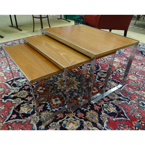 3 - A nest of three chrome framed and teak finish rectangular tables, the largest 69 x 49cm.... 