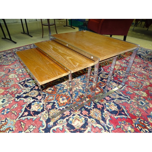 3 - A nest of three chrome framed and teak finish rectangular tables, the largest 69 x 49cm.... 