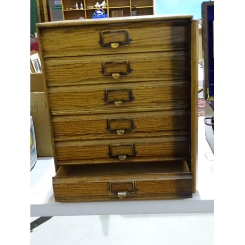 77 - A mid-20th century grained wood office table-top nest of six drawers with hinged side-locking (no ke... 