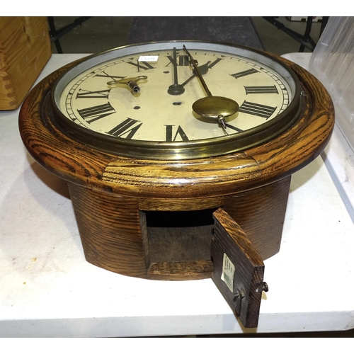 22 - An oak cased circular wall clock with single fusée movement, with key and pendulum, 40cm diam... 