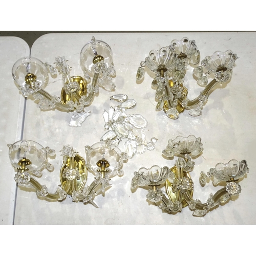 73 - A pair of modern crystal and brass three-branch wall lights with drops, 18cm high, together with ano... 