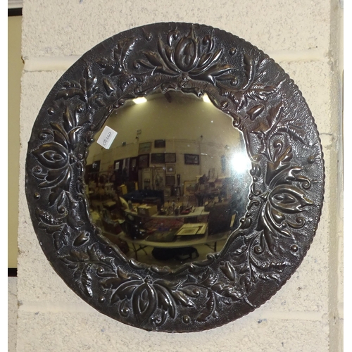 9 - An octagonal brass-framed mirror with embossed floral decoration, 49 x 34cm and a circular pewter-fr... 