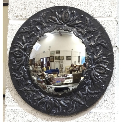 9 - An octagonal brass-framed mirror with embossed floral decoration, 49 x 34cm and a circular pewter-fr... 