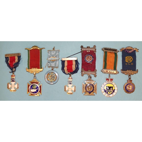 104 - A collection of Masonic jewels,  and regalia, including seven silver, together with a collection of ... 