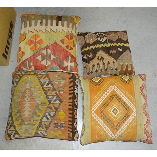 76 - Four Turkish 'carpet' cushions, other cushions and textiles.