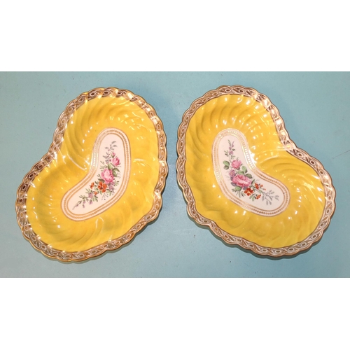 71 - A pair of early 19th century yellow-ground porcelain kidney-shaped dishes, with botanical panels to ... 