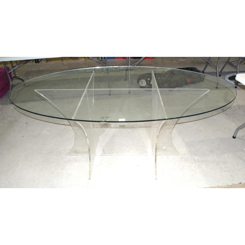 3 - A large oval glass table supported on Perspex base, (large chip to top), 183 x 102cm.... 