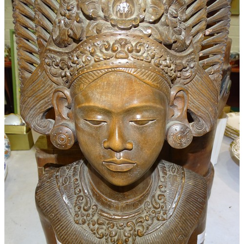 61 - An Asian carved bust of a woman wearing a headdress, 50cm high, a seated carved wood Oriental figure... 