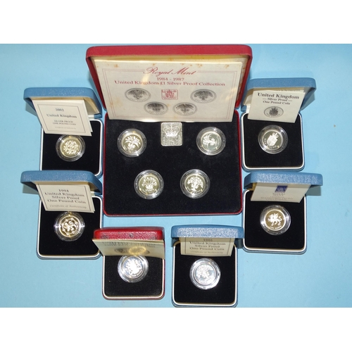 142 - The Royal Mint, a collection of seven cased silver proof £1 coins, comprising: 1983, 1984-1987... 