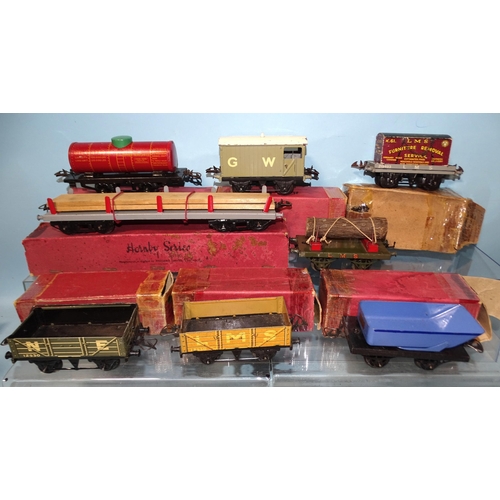 243 - Hornby, O gauge, seven boxed wagons, one unboxed, (boxes in poor condition), together with footbridg... 