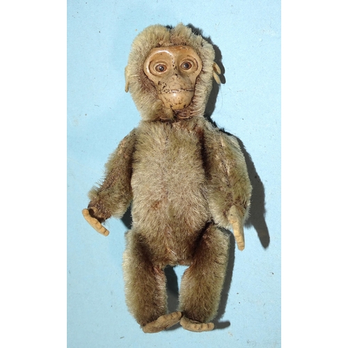 448 - A Schuco plush-covered tinplate monkey, appears to be clockwork, (not working), with felt hands and ... 