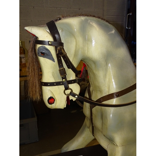 450 - A large painted rocking horse on trestle base, with removeable leather bridle, tacked on saddle, 116... 