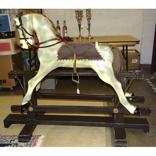 450 - A large painted rocking horse on trestle base, with removeable leather bridle, tacked on saddle, 116... 