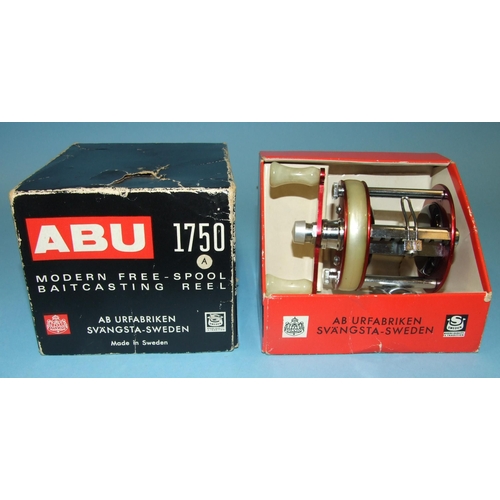 457 - An Abu 1750A reel in red, in original box, (almost unused).