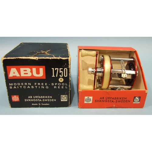 457 - An Abu 1750A reel in red, in original box, (almost unused).