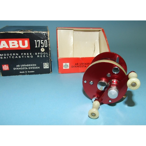 457 - An Abu 1750A reel in red, in original box, (almost unused).