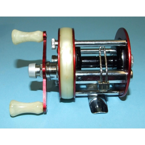 457 - An Abu 1750A reel in red, in original box, (almost unused).