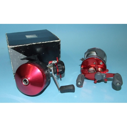 458 - An Abu Garcia Ambassador 6000 reel with instant anti-reverse, in red, in good unused condition and a... 