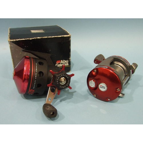 458 - An Abu Garcia Ambassador 6000 reel with instant anti-reverse, in red, in good unused condition and a... 