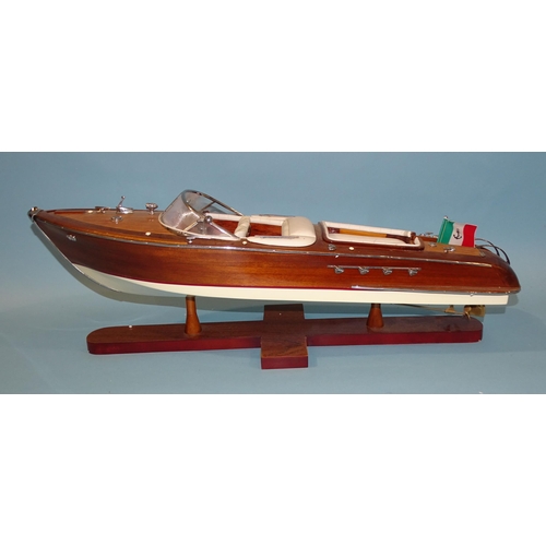 551 - A detailed model of an Italian Riva Aquarama model speedboat, 65cm long, on stand, (boxed).... 