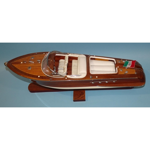 551 - A detailed model of an Italian Riva Aquarama model speedboat, 65cm long, on stand, (boxed).... 