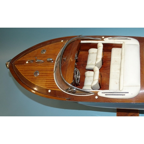 551 - A detailed model of an Italian Riva Aquarama model speedboat, 65cm long, on stand, (boxed).... 