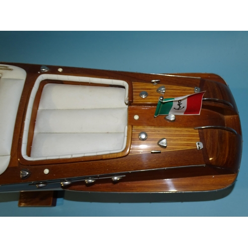 551 - A detailed model of an Italian Riva Aquarama model speedboat, 65cm long, on stand, (boxed).... 