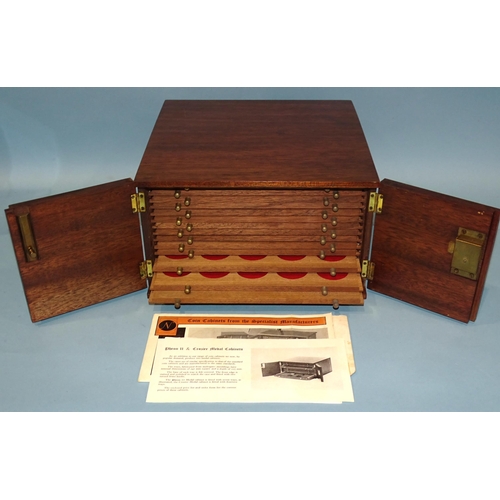 213 - A Peter Nichols 'Pheon II' mahogany coin collectors' cabinet, fitted with a pair of hinged doors ope... 