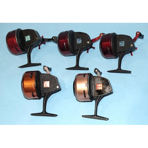 486 - Three Abu 505 castiong reels, finished red, and Abu 503 reel and an Abu 520 reel, (5).... 