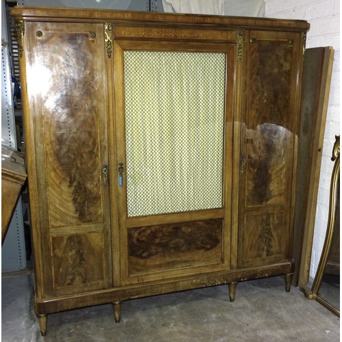 117 - A late-19th century French walnut cross-banded three-door wardrobe, the central door with silk-lined... 