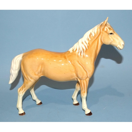 28 - A Beswick Highland pony, dun gloss, 18cm high, a Palomino (prancing Arab type) horse, 17cm high, a S... 