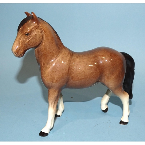 28 - A Beswick Highland pony, dun gloss, 18cm high, a Palomino (prancing Arab type) horse, 17cm high, a S... 