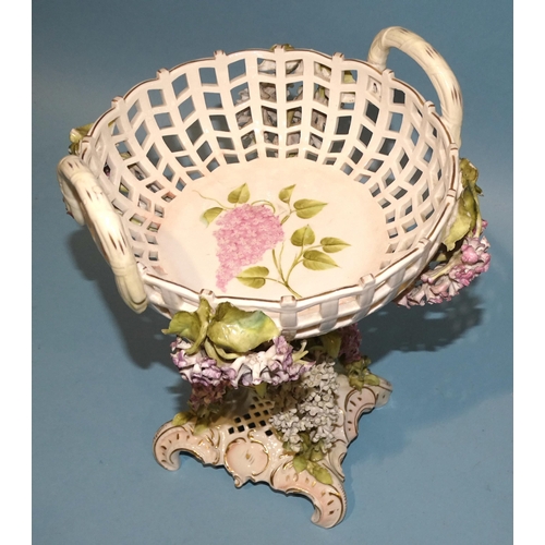 42 - A Continental porcelain basket comport decorated with pink and white lilacs, 28cm high.... 