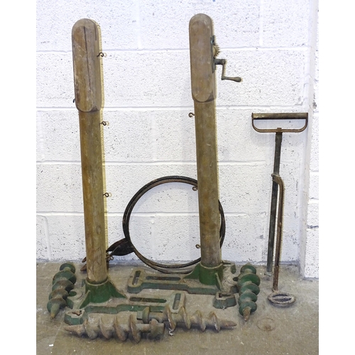 82 - A pair of 20th century wood and cast-iron tennis net posts, the cast bases marked 