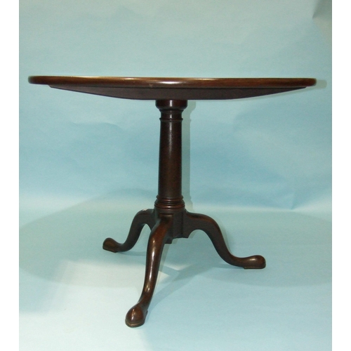 11 - *A George III mahogany tilt-top table on swept tripod support, the circular tilt-top restored, 90cm ... 