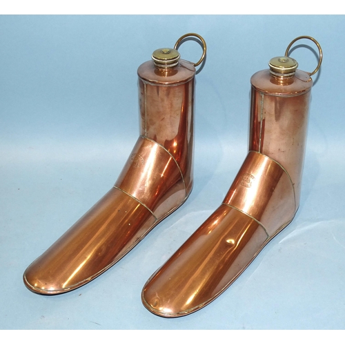 113 - A pair of copper boot warmers, Army & Navy, London, each with brass hanging loop and screw cap, ... 