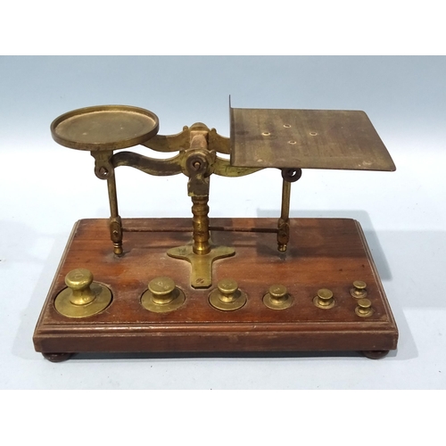 122 - A 19th/20th century brass weighing scale on walnut base, fitted with a set of weights, ¼oz to... 