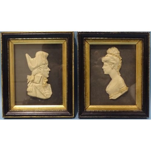 129 - A 19th century wax bust of a young woman, in frame, with a companion bust of a military gentleman, l... 