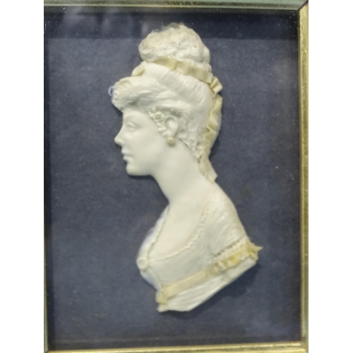 129 - A 19th century wax bust of a young woman, in frame, with a companion bust of a military gentleman, l... 