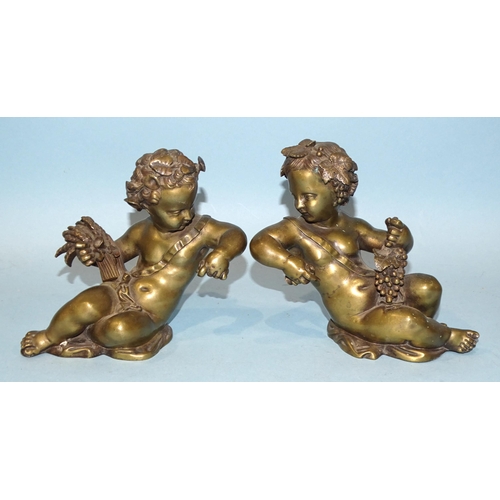 137 - A pair of bronze cherubs in a reclining posture, holding wheatsheaf and grapes, 14cm high, (clock or... 