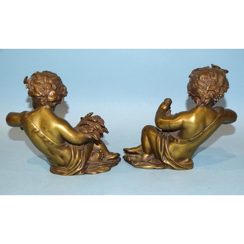 137 - A pair of bronze cherubs in a reclining posture, holding wheatsheaf and grapes, 14cm high, (clock or... 